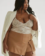 PLERIVA Breathable Lace V-Neck Bodysuit in White, styled with a blazer and skirt