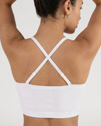 PLERIVA Convertible Invisible Support Bra in White, crisscross back view with arms raised