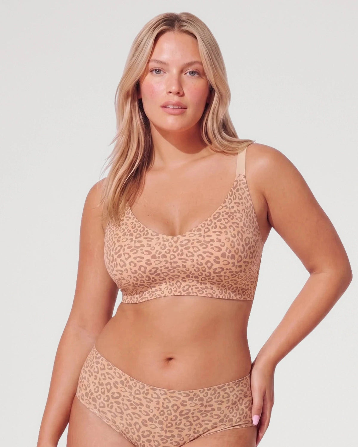 PLERIVA Deep V Lace Racerback Bralette in Light Leopard, front view with matching brief, hand on hip