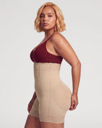 PLERIVA High Waist Tummy Control Sculpting Shorts in Nude, side view on model