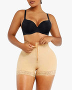 PLERIVA Lace Steel Boned Tummy Control Shorts in Beige, front view while fastening the zipper