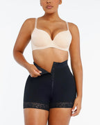 PLERIVA Lace Steel Boned Tummy Control Shorts in Black, front view while fastening the hooks