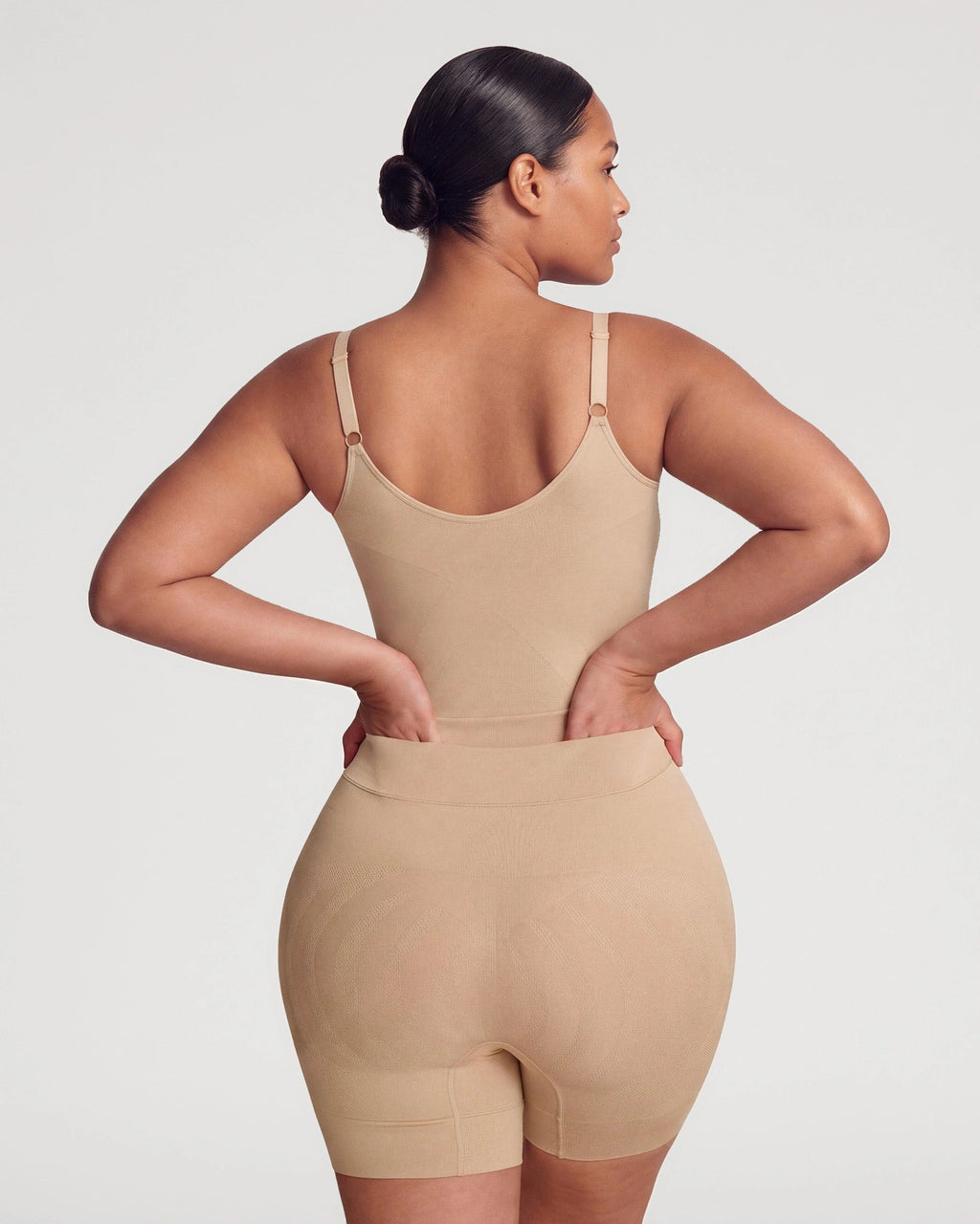 PLERIVA Seamless Full Body Sculpting Bodysuit in Nude, back view on model