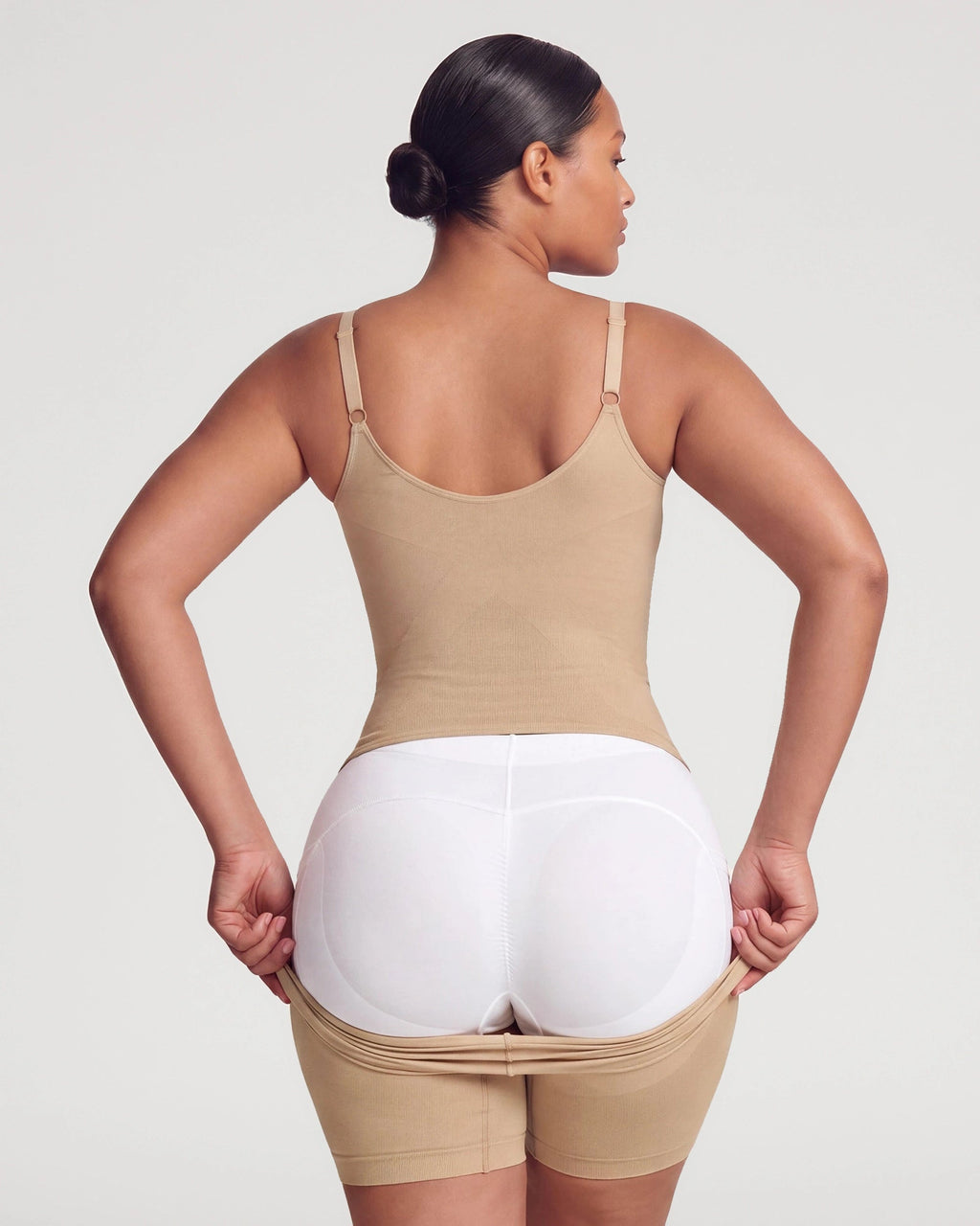 PLERIVA Seamless Full Body Sculpting Bodysuit in Nude, back view showing the pull-away opening