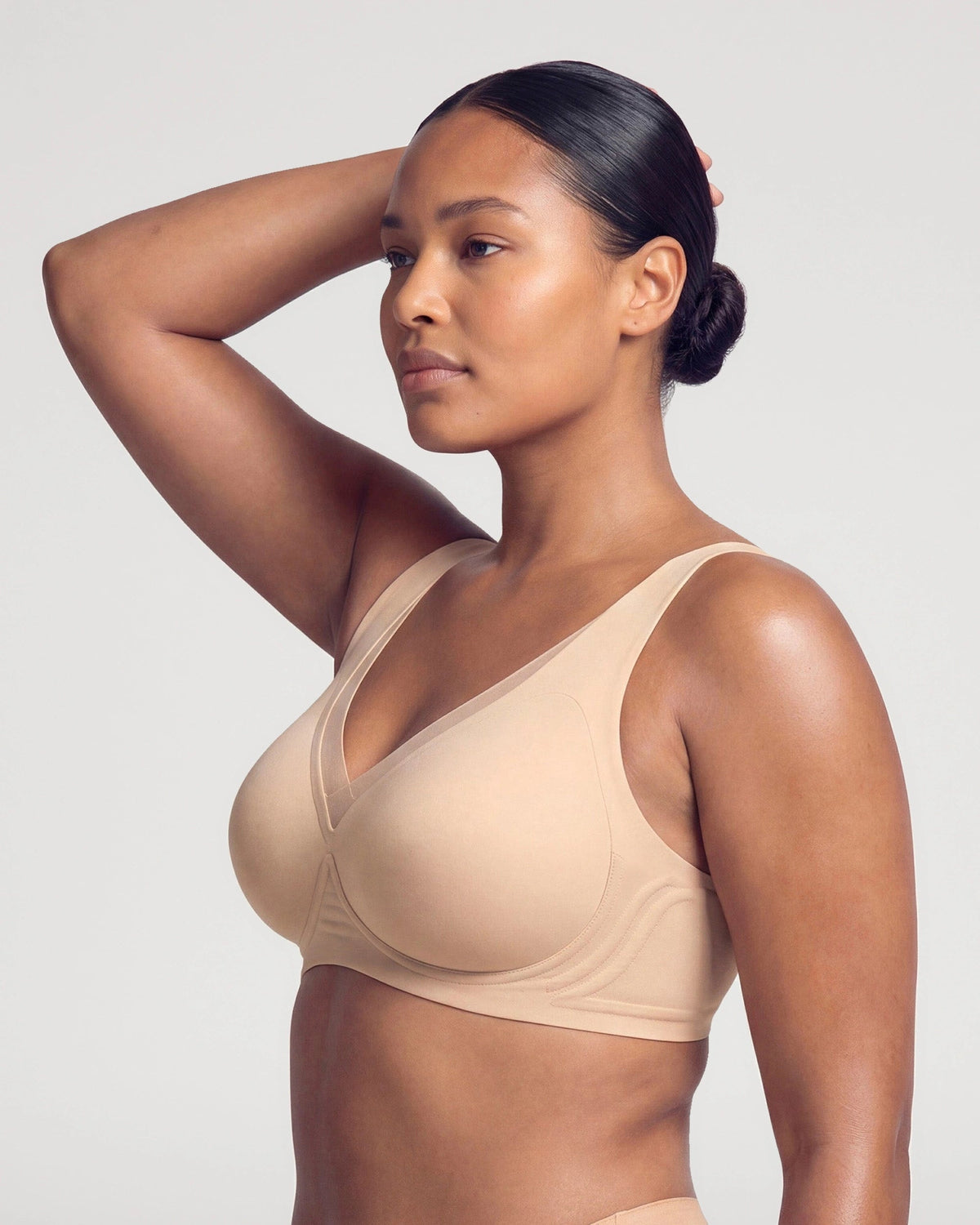 PLERIVA Seamless Mesh Wireless Plunge Lift Bra in Nude, side view with arm raised