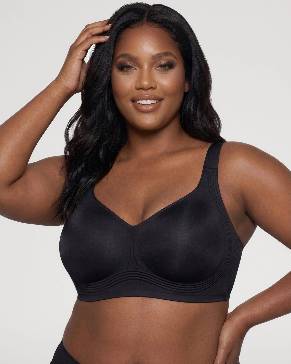 PLERIVA Seamless Wireless Full Coverage Lift Bra in Black, front view on model with hand in hair