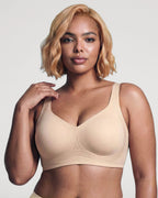 PLERIVA Seamless Wireless Full Coverage Lift Bra in Nude, front view on model with hand on shoulder
