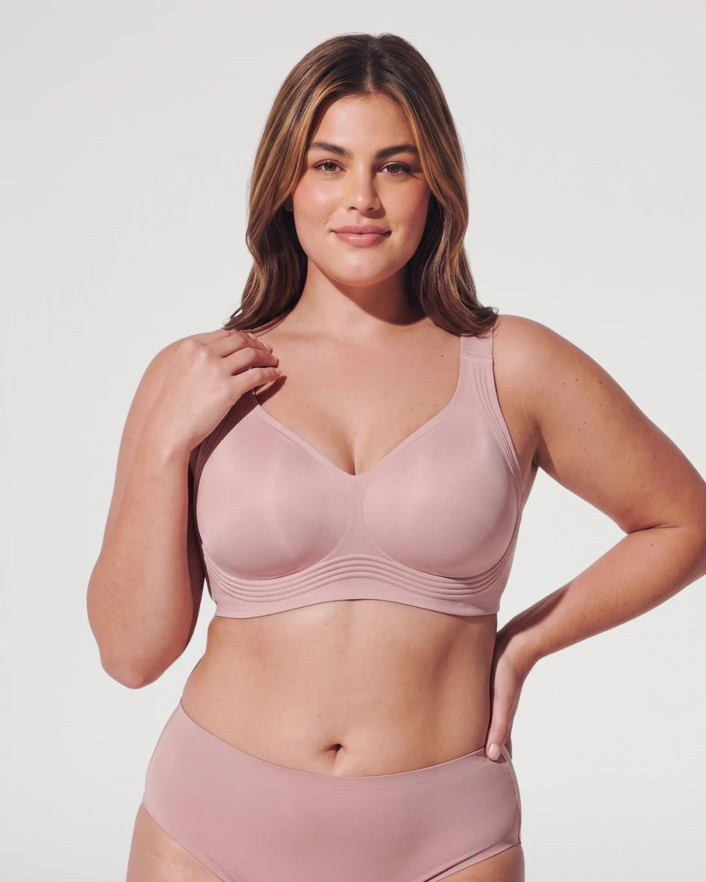 PLERIVA Seamless Wireless Full Coverage Lift Bra in Nude Pink, front view on model with hand on shoulder