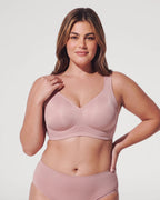 PLERIVA Seamless Wireless Full Coverage Lift Bra in Nude Pink, front view on model with hand on shoulder