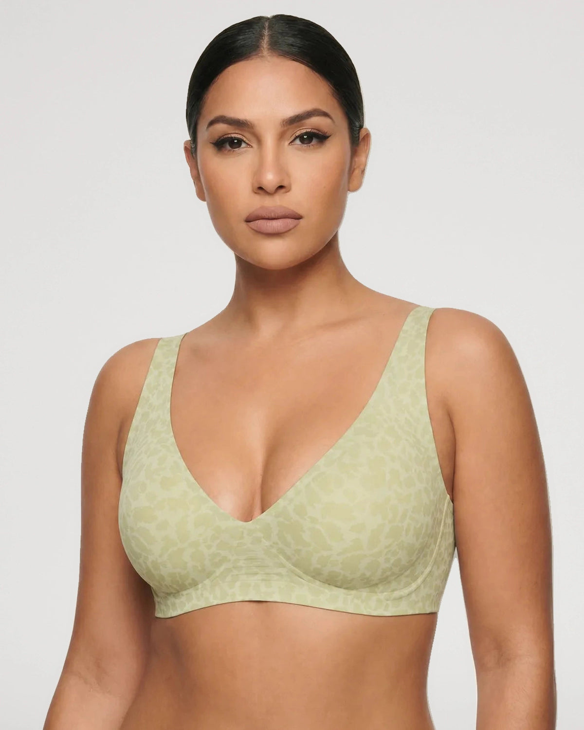 PLERIVA Seamless Wireless Plunge Lift Bra in Green Leopard, front view on model