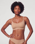 PLERIVA Unlined Scoop Neck Wireless Bralette in Nude, front view on model