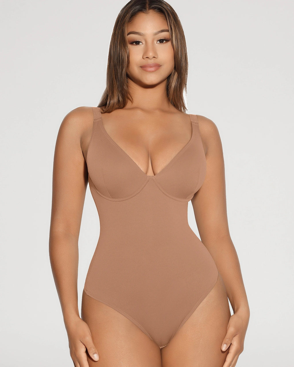 PLERIVA V-Neck Tummy Control Sculpting Bodysuit, standing front view on model in a tan shade