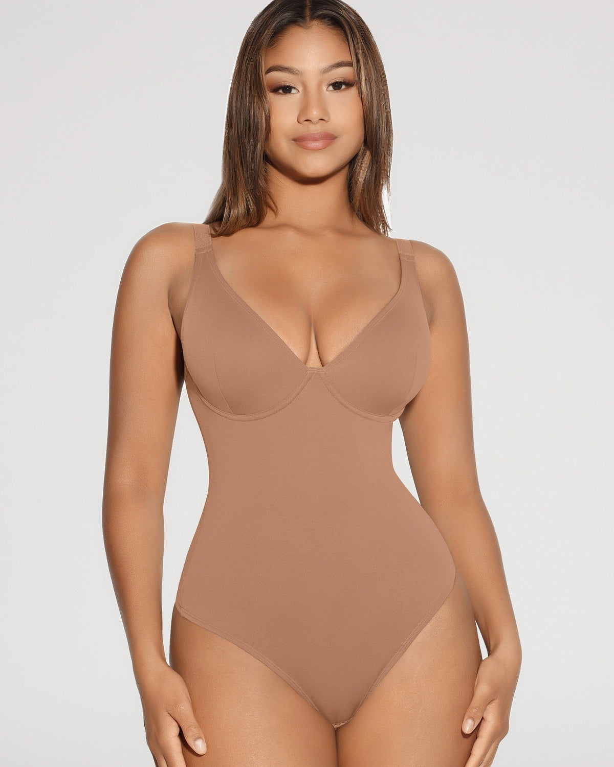 PLERIVA V-Neck Tummy Control Sculpting Bodysuit, standing front view on model in a tan shade