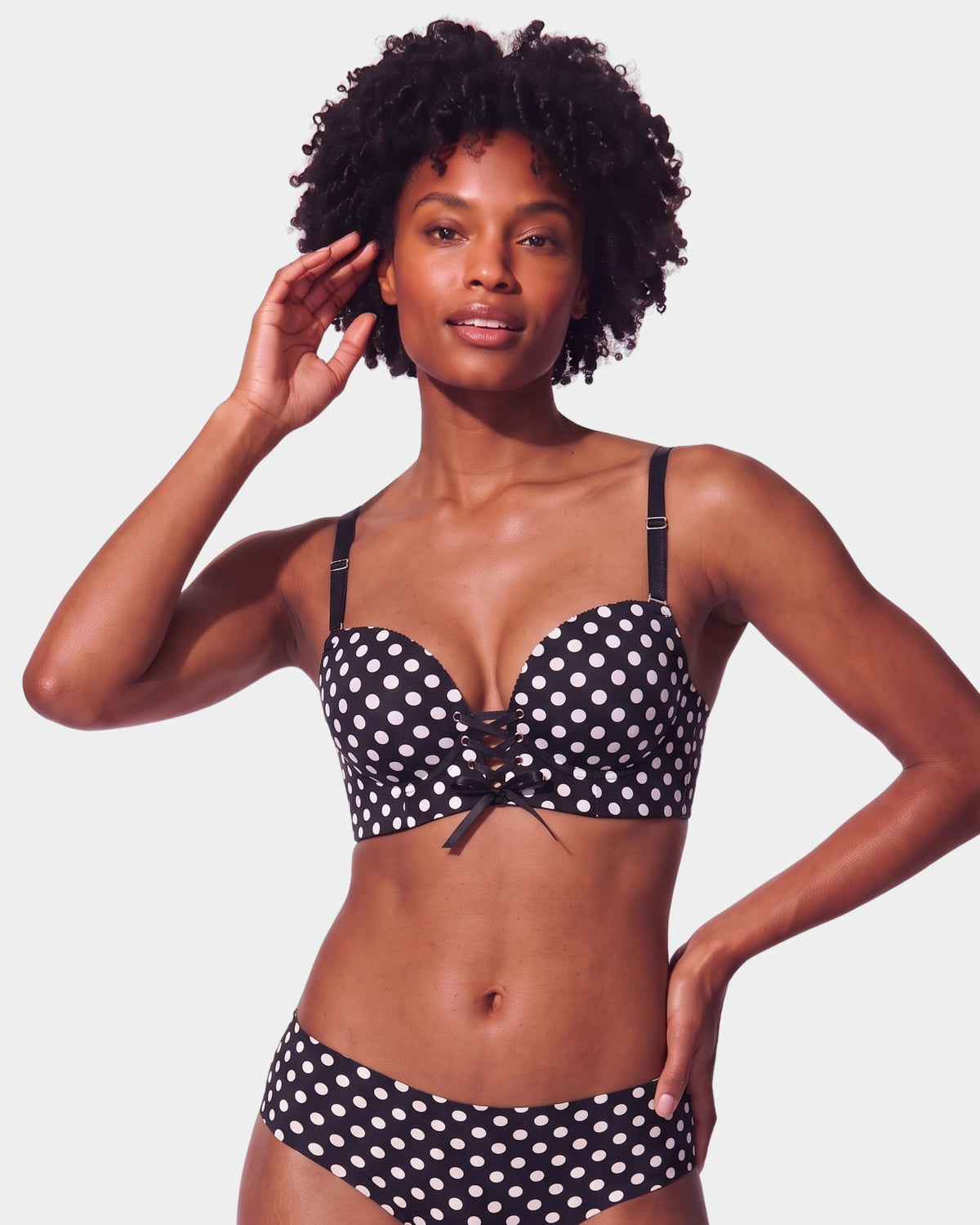 PLERIVA Wireless Lift Bra with Lace-Up Front in Black polka dot, front view on model showing the lace-up front