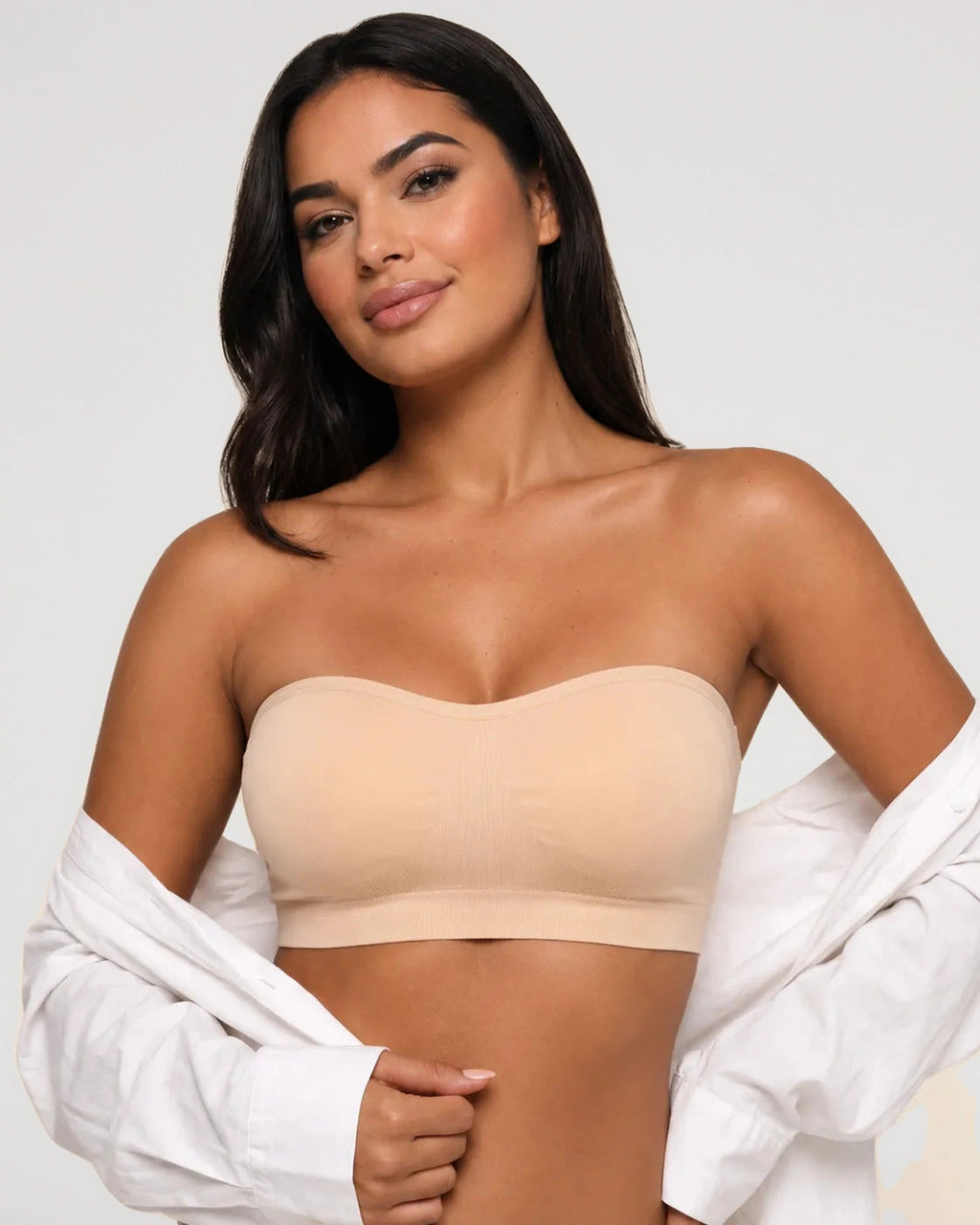 PLERIVA Wireless Seamless Strapless Bandeau in Nude, front view styled with an open shirt